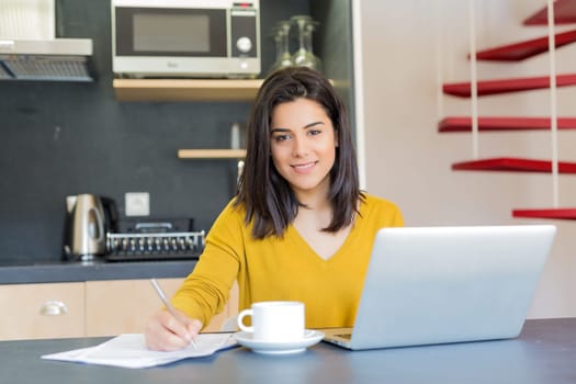 Young woman working at home in the morning