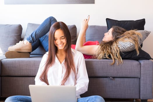 Happy friends relaxing at the living room