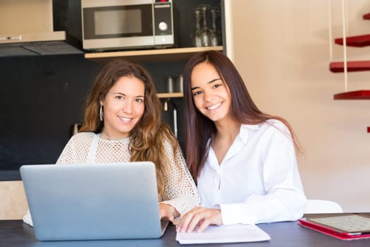 Beautiful young women at home studying for the final exams