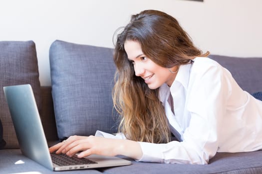 Beautiful woman relaxing with a computer