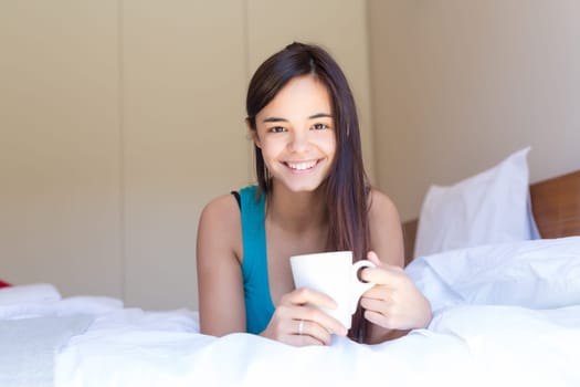Happy young woman relaxing in the morning