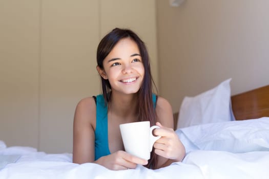 Happy young woman relaxing in the morning
