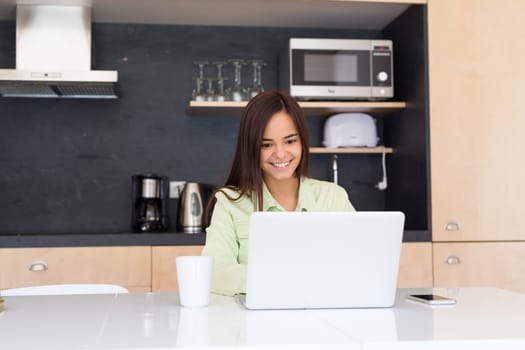 Young woman working at home in the morning