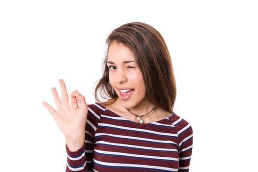 Beautiful young woman signaling ok, isolated over white