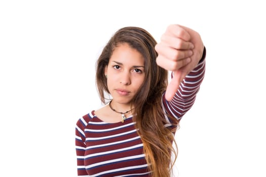 Studio shot of a young woman signaling thumbs down