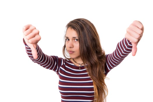 Studio shot of a young woman signaling thumbs down