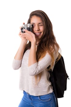 Beautiful woman holding a vintage camera, isolated over white background