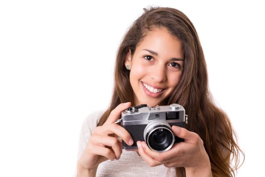 Beautiful woman holding a vintage camera, isolated over white background