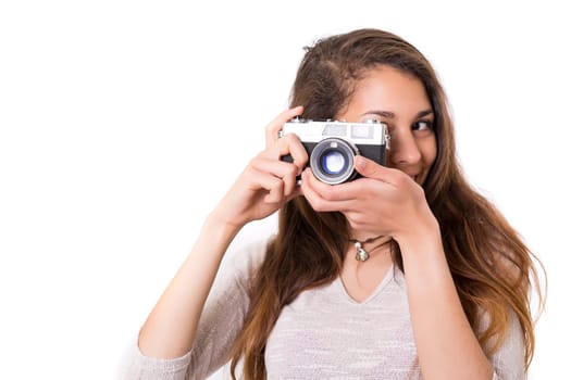 Beautiful woman holding a vintage camera, isolated over white background