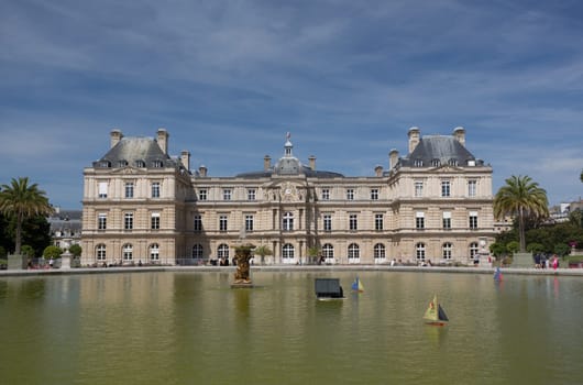 PARIS - AUGUST 13: Children's ships in fountain near Luxembourg Palace in the Luxembourg Garden on August 13, 2016 in Paris, France. Toy ships is most popular entertainment on Luxembourg Garden.