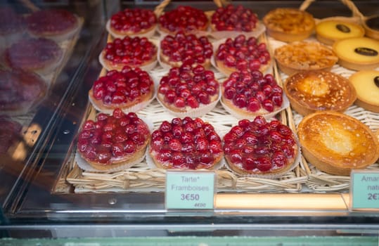 Local patiserie in Paris showing the typical french pastries: raspberry pies
