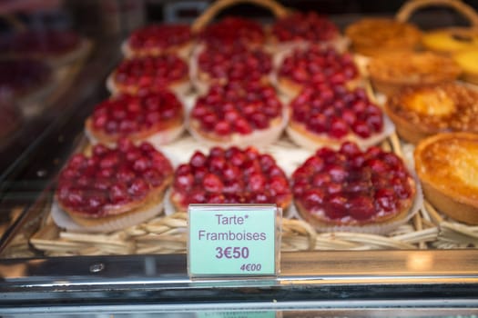 Local patiserie in Paris showing the typical french pastries: raspberry pies