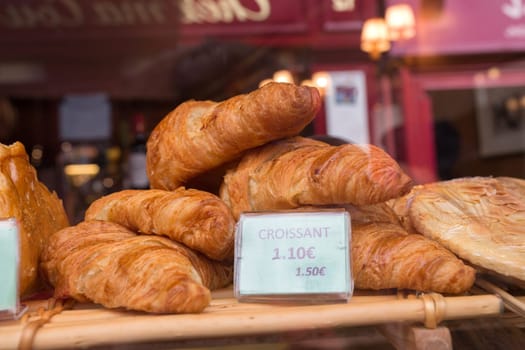 Local patiserie in Paris showing the typical french pastries: croissants