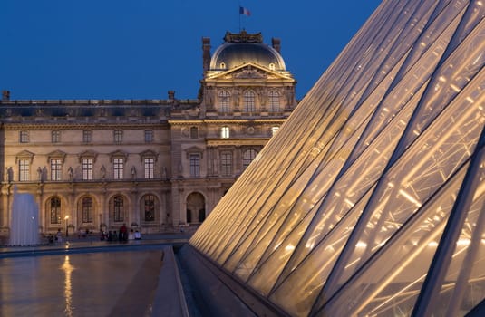 PARIS - AUGUST 15, 2016 Louvre museum at twilight in summer. Louvre Museum is one of the world's largest museums, every year museum visits more than 8 million visitors.