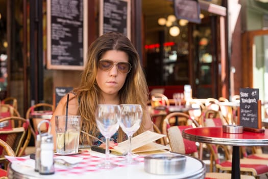 Beautiful young woman at a typical french restaurant