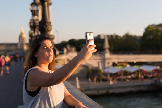 Lucky woman in Paris taking a selfie to post on social networks