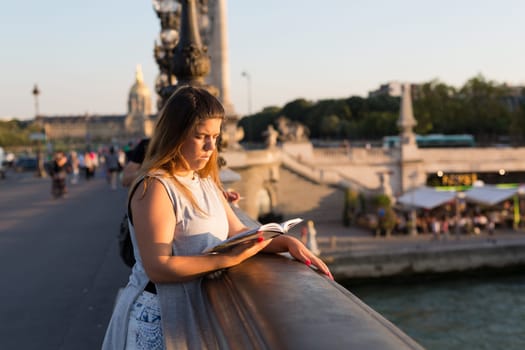 Young woman on vacations in Paris, relaxing over the Alexander the 3rd bridge