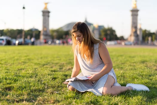 Lucky girl relaxing in the gardens next to the Invalides and the Alexander the 3rd bridge in Paris