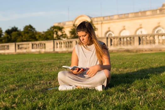 Lucky girl relaxing in the gardens next to the Invalides and the Alexander the 3rd bridge in Paris at the sunset