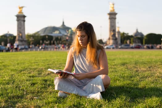 Lucky girl relaxing in the gardens next to the Invalides and the Alexander the 3rd bridge in Paris