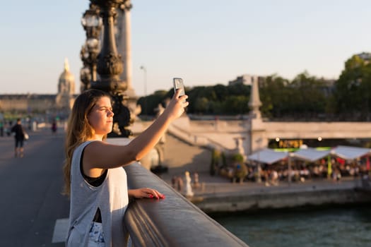 Lucky woman in Paris taking a selfie to post on social networks