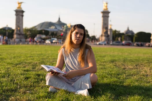 Lucky girl relaxing in the gardens next to the Invalides and the Alexander the 3rd bridge in Paris
