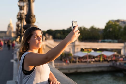 Lucky woman in Paris taking a selfie to post on social networks