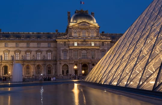 PARIS - AUGUST 15, 2016 Louvre museum at twilight in summer. Louvre Museum is one of the world's largest museums, every year museum visits more than 8 million visitors.