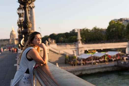 Young woman on vacations in Paris, relaxing over the Alexander the 3rd bridge