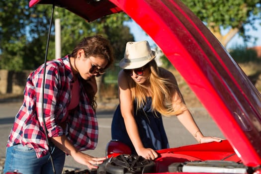 Friends on a roadtrip having a problem with their old car