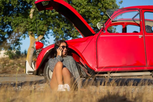 Woman on a roadtrip having a problem with her old car