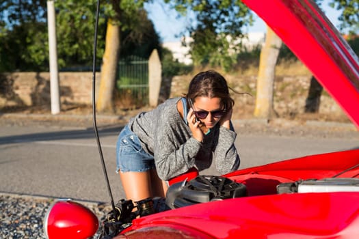 Woman on a roadtrip having a problem with her old car