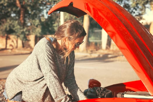Woman on a roadtrip having a problem with her old car
