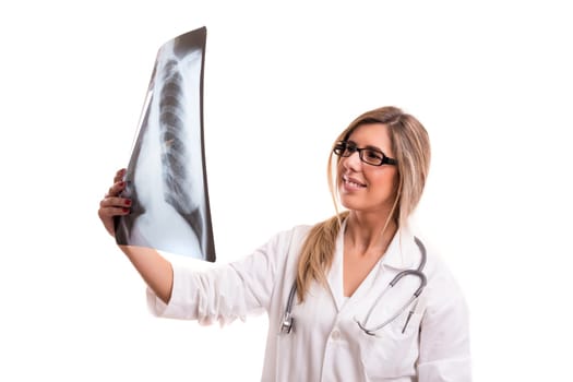 Beautiful young doctor looking at some exams, isolated over white