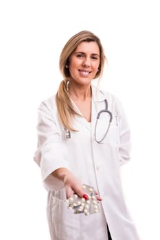 Medic holding some pills, isolated over white