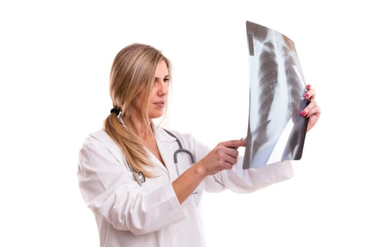 Beautiful young doctor looking at some exams, isolated over white