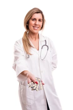 Medic holding some pills, isolated over white