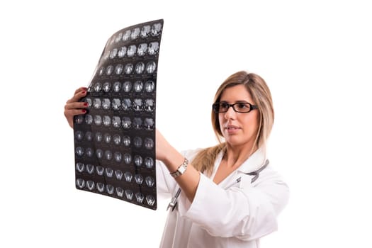 Beautiful young doctor looking at some exams, isolated over white