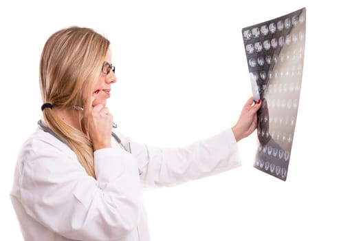 Beautiful young doctor looking at some exams, isolated over white