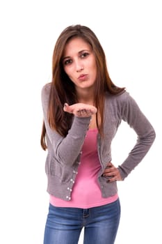 Beautiful young woman blowing you a kiss, isolated over white