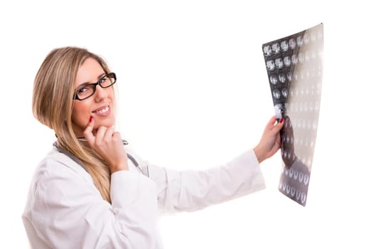 Beautiful young doctor looking at some exams, isolated over white