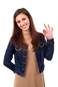 Beautiful young woman signaling ok, isolated over white