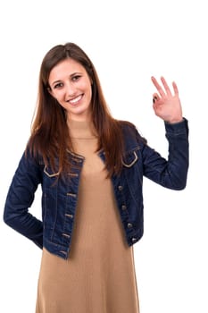 Beautiful young woman signaling ok, isolated over white