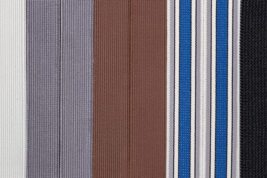 Elastic band texture. Close-up of a variety of colorful elastic bands for clothing and furniture. Used in the manufacture and repair of clothing. Macro photograph.