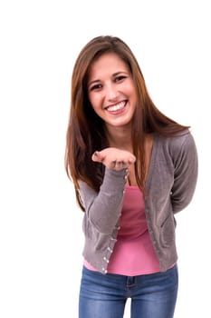 Beautiful young woman blowing you a kiss, isolated over white