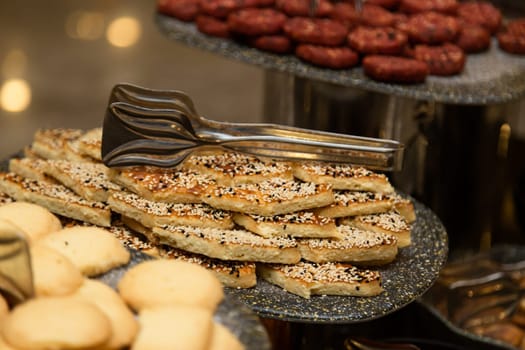 Buffet table with various cookies and biscuits, tarts and cakes.