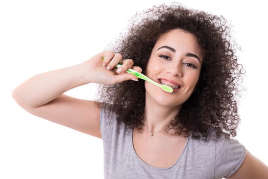 Young asian woman, who weares braces, getting ready to brush the teeth