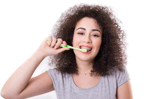 Young asian woman, who weares braces, getting ready to brush the teeth