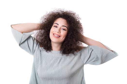 Happy young woman - who weares braces - posing isolated over white