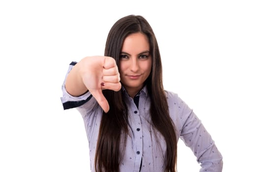 Studio shot of a young woman signaling thumbs down